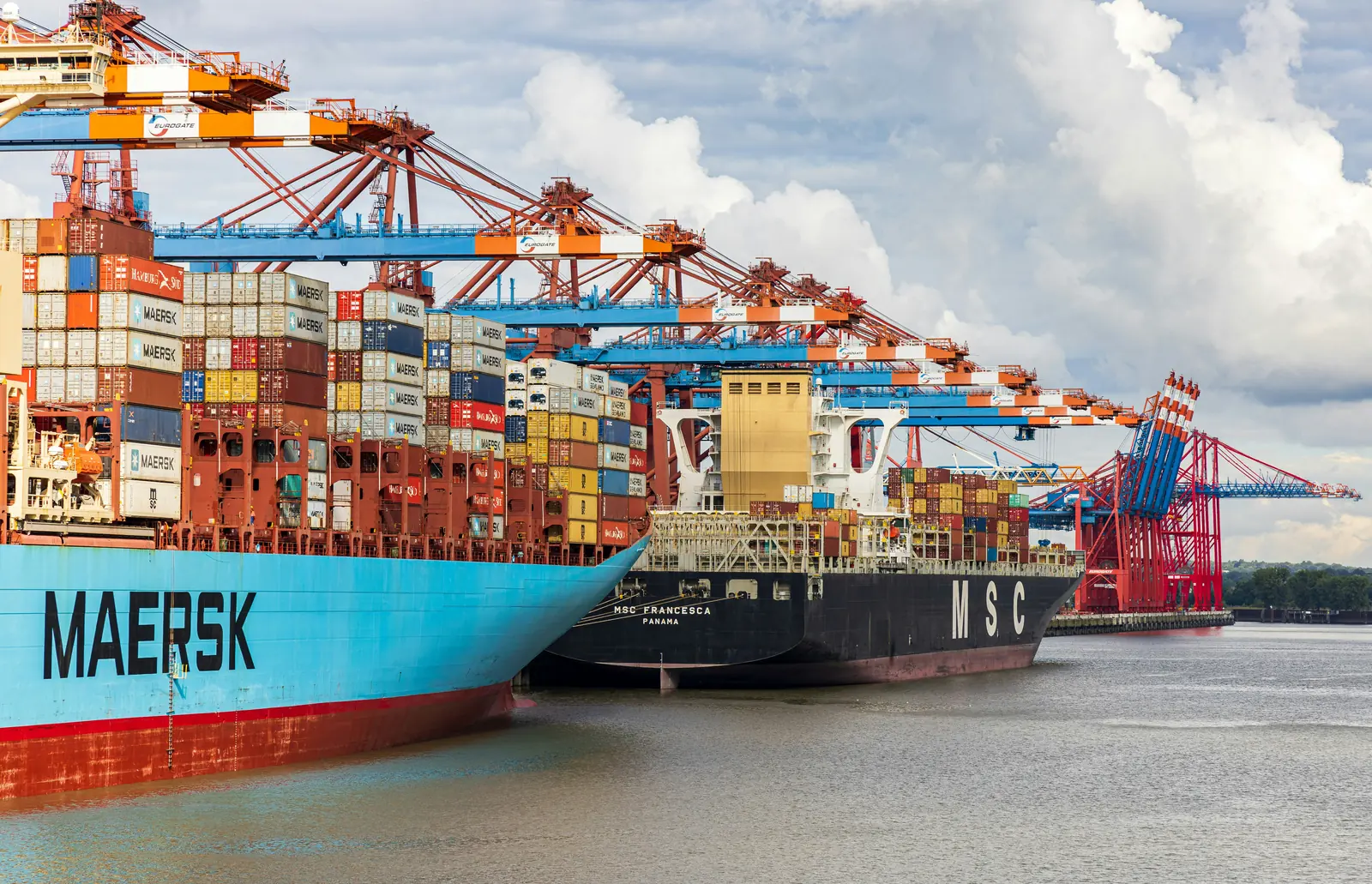 Container ships berthed under gantry cranes at a port terminal