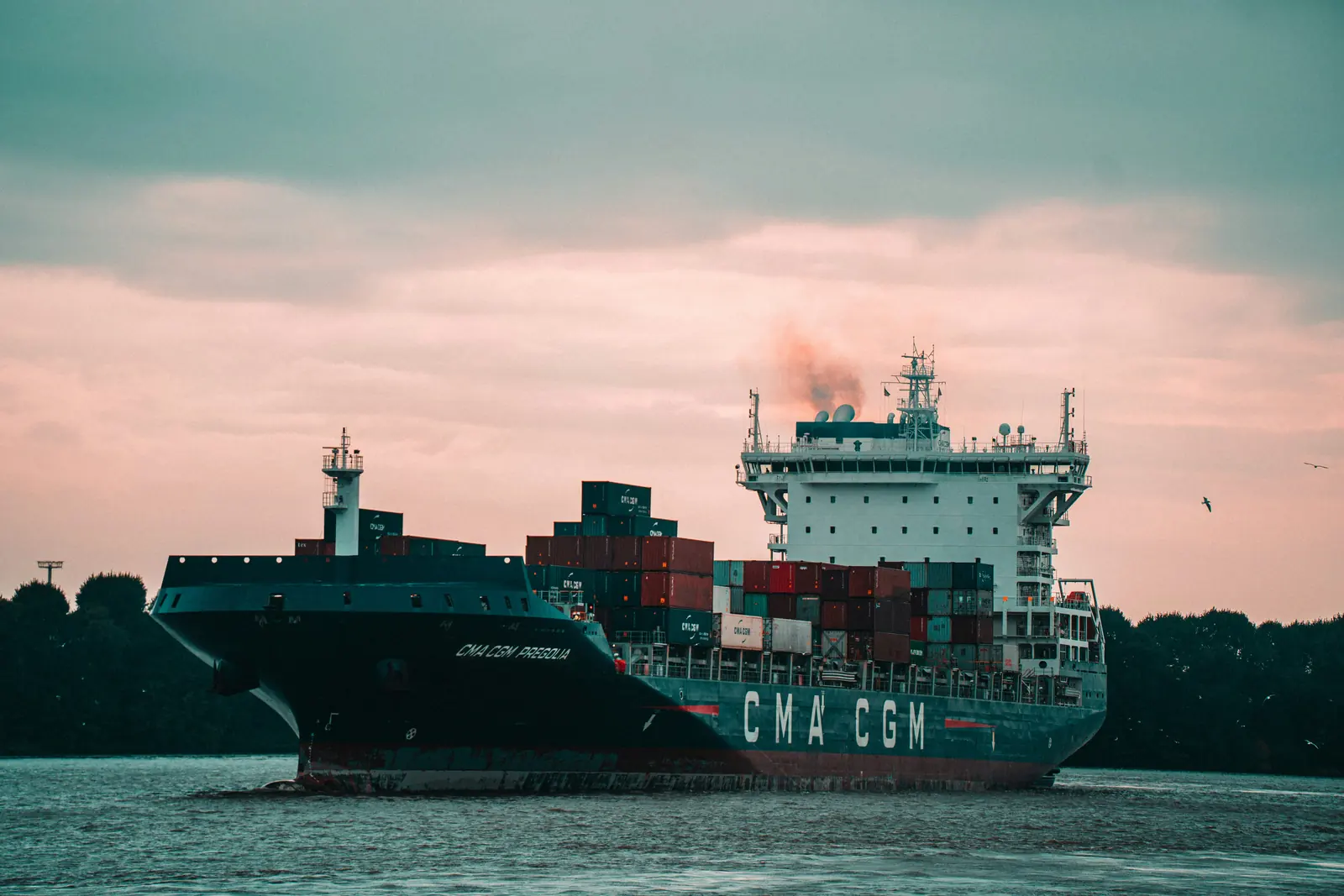 Loaded container vessel sailing along the coast