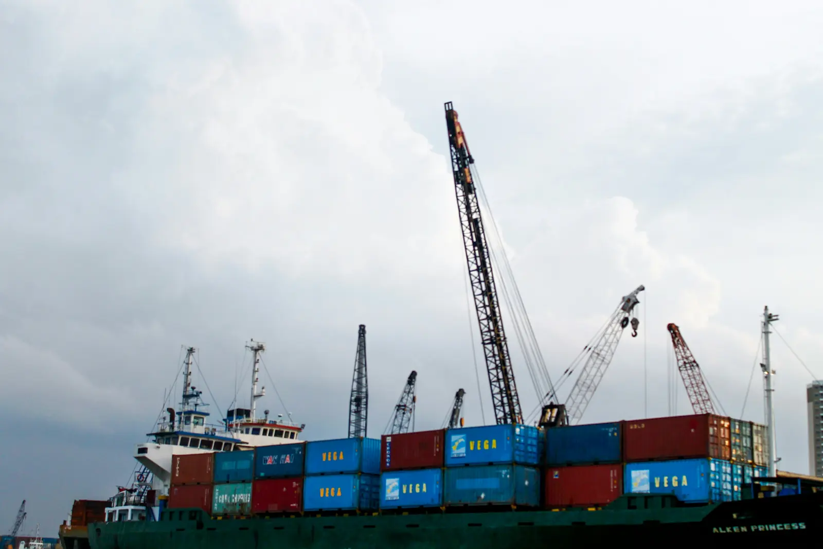 Container ship alongside port cranes ready for discharge
